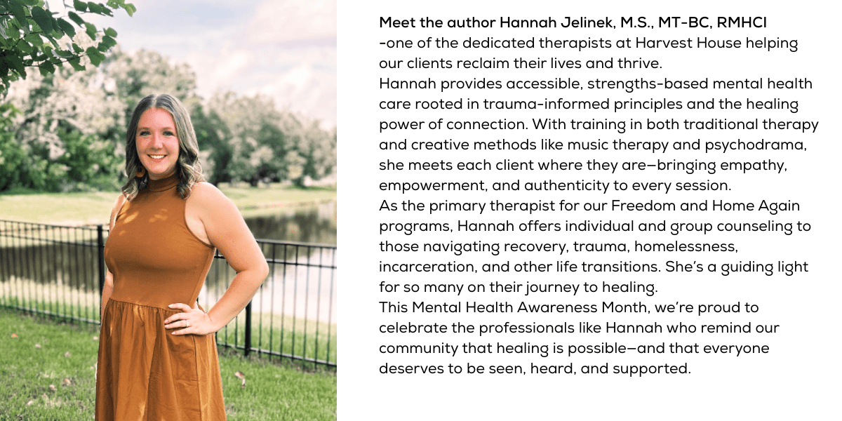 Meet Hannah Jelinek: Guiding Healing Through Compassion and Creativity Hannah Jelinek, a young woman with wavy light brown hair wearing a sleeveless rust-colored dress, stands smiling in front of a peaceful pond and tree-lined park, next to a black metal fence.