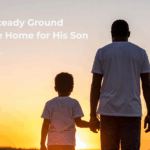 A father and his young son stand side by side at sunset, holding hands and looking toward the horizon—representing hope, healing, and a new beginning through Harvest House’s Home Again program.