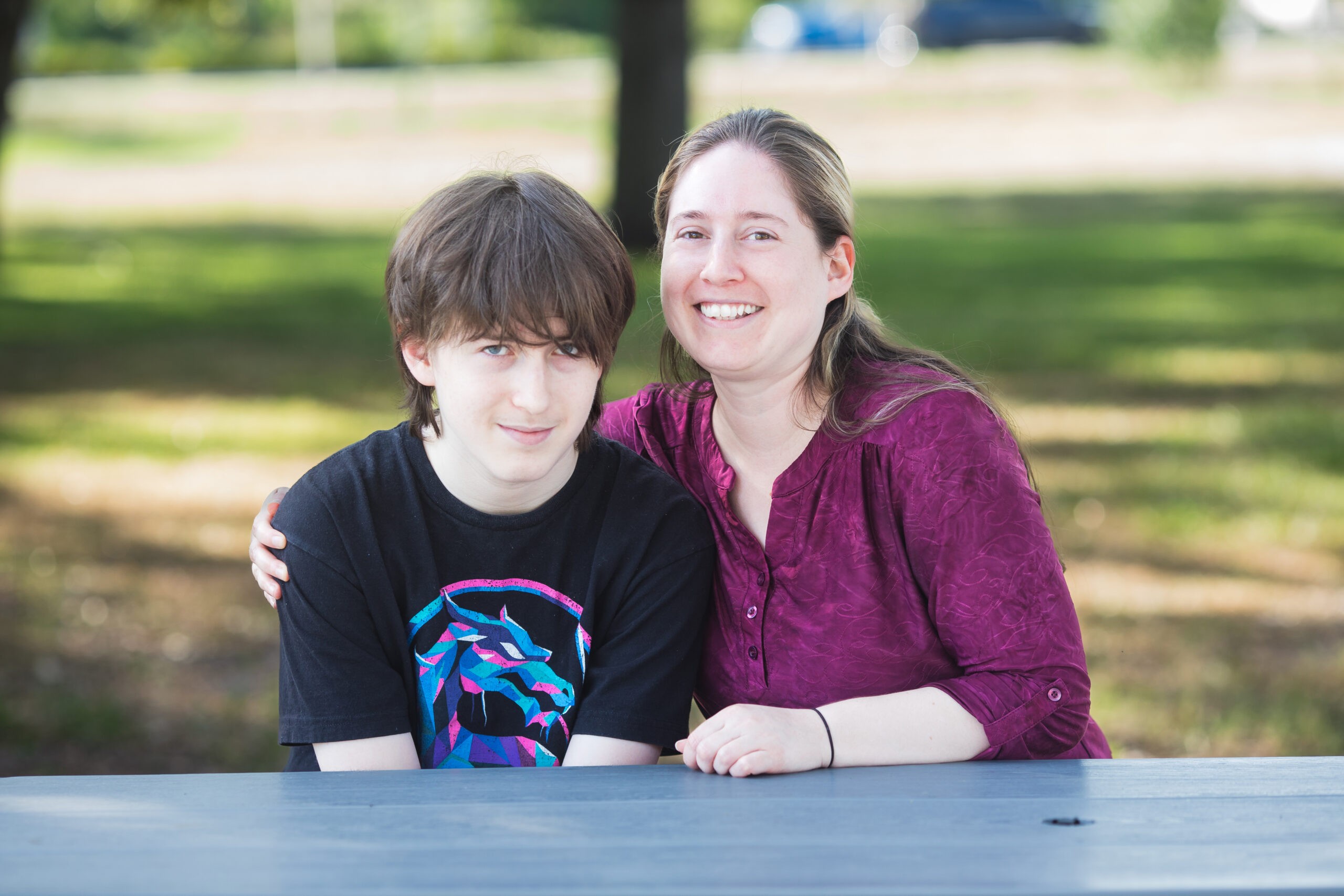 Sarah and her son Bradin smiling together outdoors