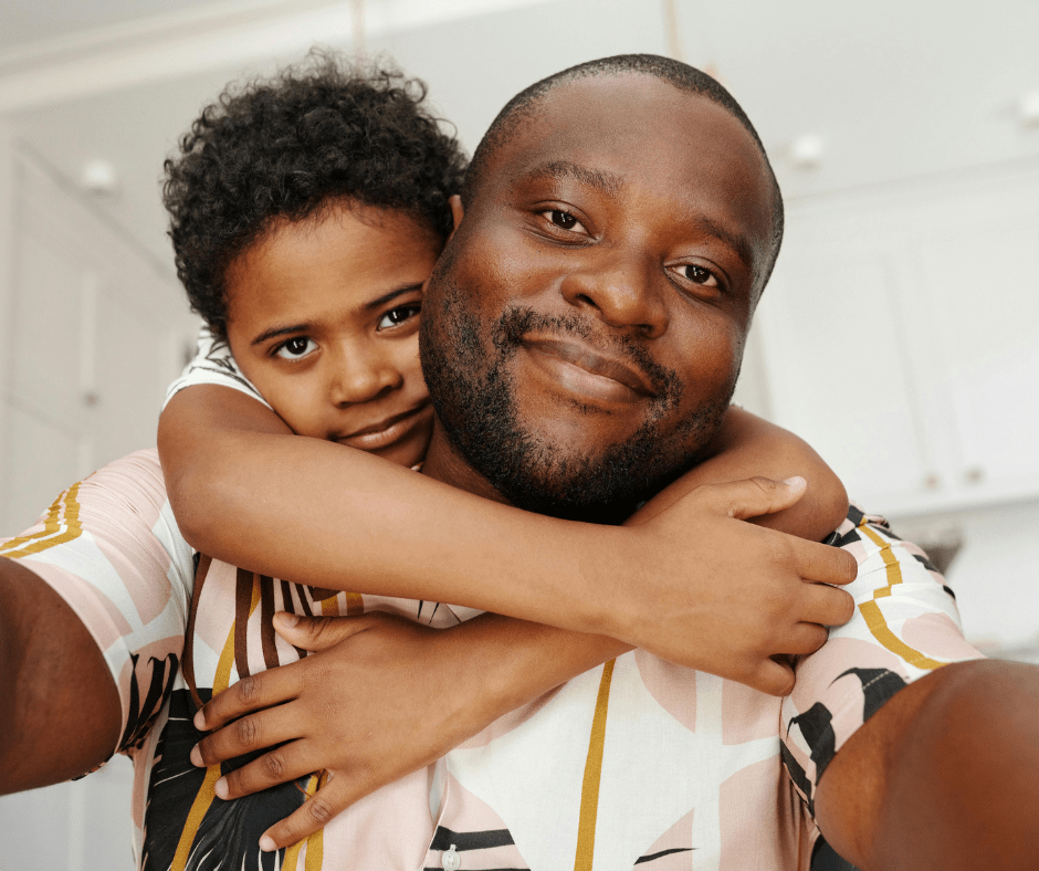 Father and son embracing with smiles of hope and belonging